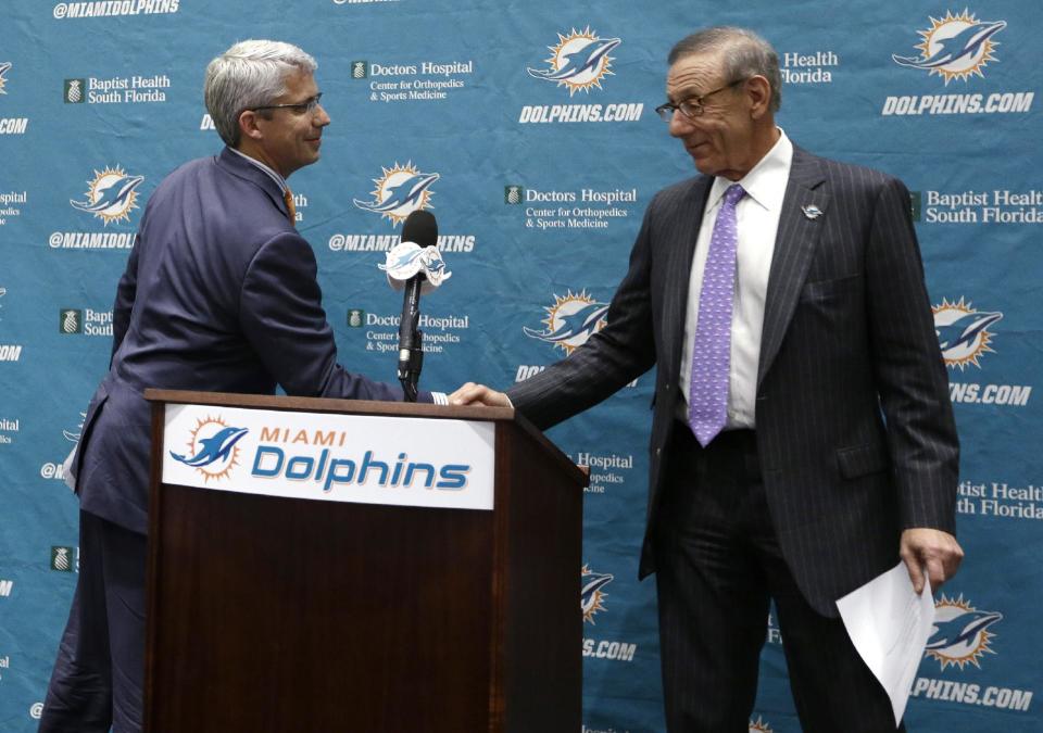 Dennis Hickey, left, the new general manager for the Miami Dolphins NFL football team, shakes hands with team owner Stephen Ross during a news conference Tuesday, Jan. 28, 2014, in Davie, Fla. (AP Photo/Lynne Sladky)