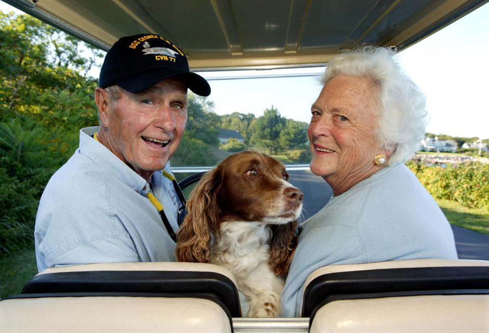 Former President George H.W. Bush and wife, Barbara Bush, cruising around in the back of a golf cart with their dog Millie at their home at Walker's Point in Kennebunkport, ME, on Aug. 25, 2004.