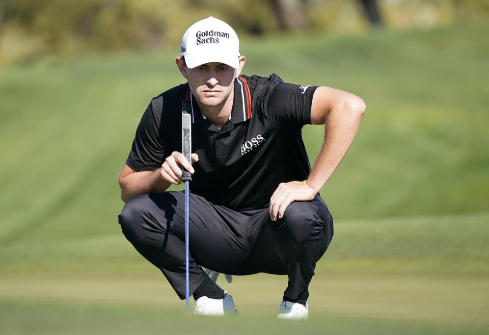 Patrick Cantlay prepares to putt on the second hole during the Phoenix Open golf tournament Friday, Feb. 11, 2022, in Scottsdale, Ariz. (AP Photo/Darryl Webb)