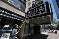 Kevin Norsworthy, State Theater's "marquee master," puts a new message outside the venue, Tuesday, June 16, 2020, in Portland, Maine. Norsworthy, who is optimistic the State will survive because of local community support, said 90 percent of independent concert venues around the country may close permanently due to the coronavirus pandemic. The theater still does not have any plans for reopening but has rescheduled some cancelled shows for next year. (AP Photo/Robert F. Bukaty)