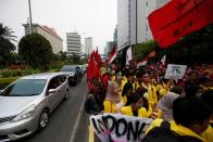 University students take part in a protest with Indonesian labour organisations over human rights, corruption and social and environmental issues in Jakarta, Indonesia