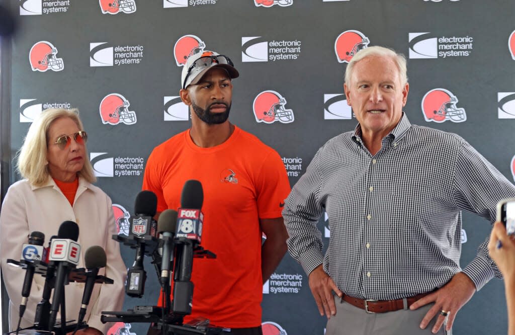 Cleveland Browns managing and principal partner Jimmy Haslam, right, speaks to the media, Thursday, Aug. 18, 2022, in Berea, Ohio, after the team announced that quarterback Deshaun Watson has reached a settlement with the NFL and will serve an 11-game unpaid suspension and pay a $5 million fine rather than risk missing his first season as quarterback of the Cleveland Browns following accusations of sexual misconduct while he played for the Houston Texans. Browns general manager and executive vice president of football operations Andrew Berry, center, and Browns managing and principal partner Dee Haslam listen. (Joshua Gunter/Cleveland.com via AP)