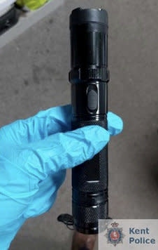 A taser disguised as a torch, also found during the raid.  SWNS