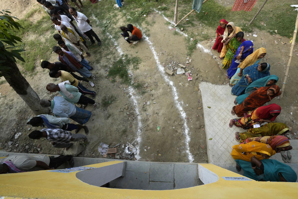 People stand in a queue to cast their votes during the fourth phase of general election, on the outskirts of Samastipur, in the Indian state of Bihar, Monday, May 13, 2024. (AP Photo/Manish Swarup)