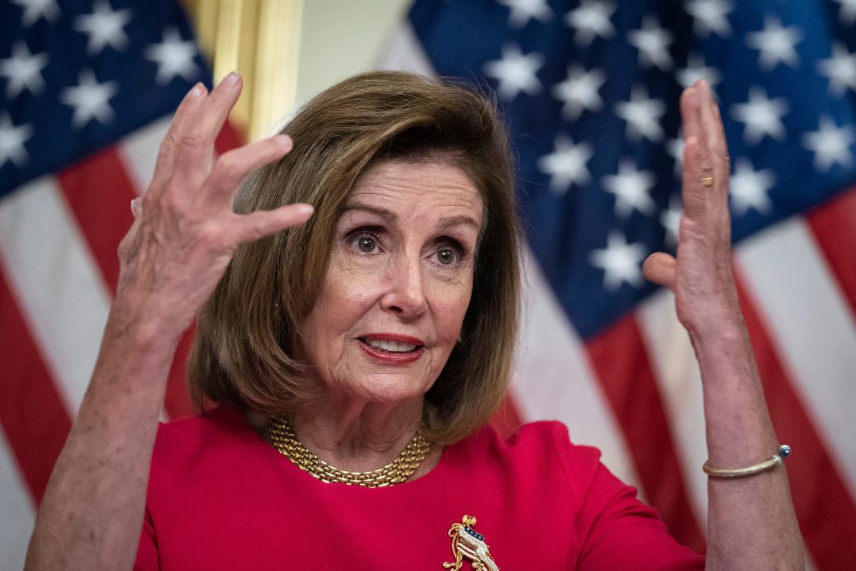 Nancy Pelosi raising hands