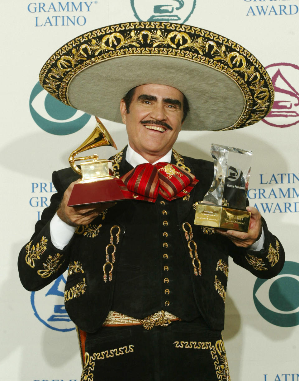 Mexican singer Vicente Fernandez holds up the Latin Grammy award (L) for Best Ranchero
Album he won for 