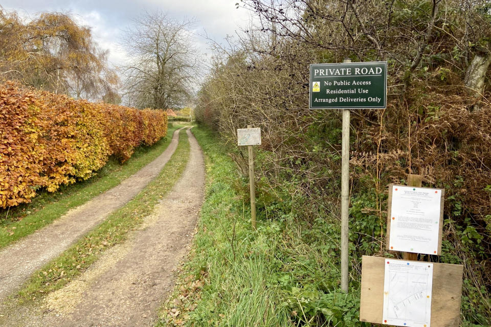 The private road entrance off St James's Road, Newton.  Release date – November 19, 2023.  See SWNS story SWLSbarricade.  The Nar Valley Way is one of Norfolk’s flagship footpaths, traversing an uninterrupted 33 miles of the county's ancient woodland and open green pastures. Or almost uninterrupted - Any ramblers reaching the tiny hamlet of Newton by Castle Acre will find their way impeded by an unsightly 4ft barricade made from wooden stakes.  To deter any intrepid walkers from attempting to scale the structure, the poles have even been smeared with greasy anti-climb paint, with nearby signs warning them they are being monitored on CCTV.  This rural rampart blocking around 150m of the footpath is the result of an extraordinary legal row in the village which has raged for 30 years and this week culminated in a two-day public inquiry, chaired by a government inspector.  The palisade was erected by Sine Garvie-McInally, a former Norfolk County Council (NCC) solicitor who lives in a charming cottage next to the Nar Valley Way, as a way to stop the path being used.  She claims it is has never officially been recorded as a public right of way and that this cannot now be done, retrospectively, because the route passes too close to her home and infringes her right to privacy. 