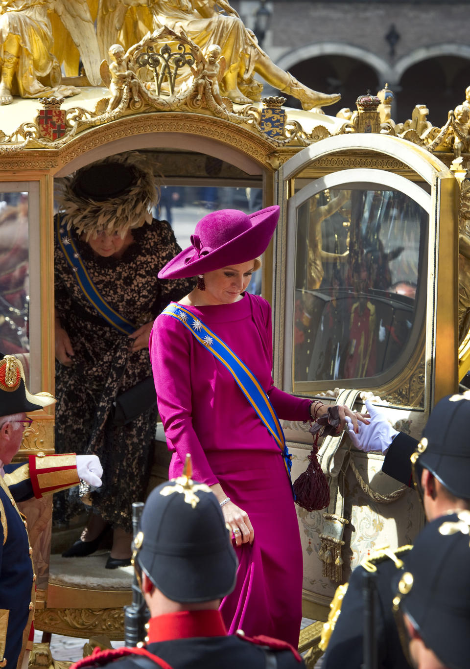 Princess Maxima, centre and Dutch Queen Beatrix, left as they leave the gold-trimmed carriage after arriving at the "Hall of Knights" for the formal opening of the new parliamentary year in The Hague, Netherlands, Tuesday, Sept. 18, 2012. Queen Beatrix will address the nation amid the usual pomp and circumstance, but the in uncomfortable knowledge that her speech was written by a Cabinet that is about to be replaced after national elections last week. (AP Photo/Paul Vreeker, Pool)