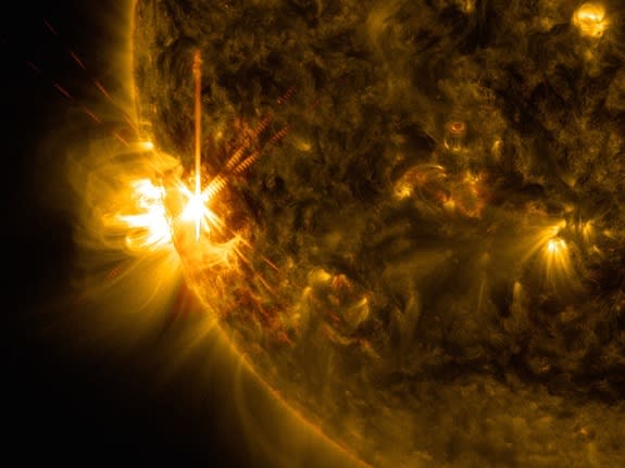 A solar flare bursts off the left limb of the sun in this image captured by NASA's Solar Dynamics Observatory on June 11, 2014.