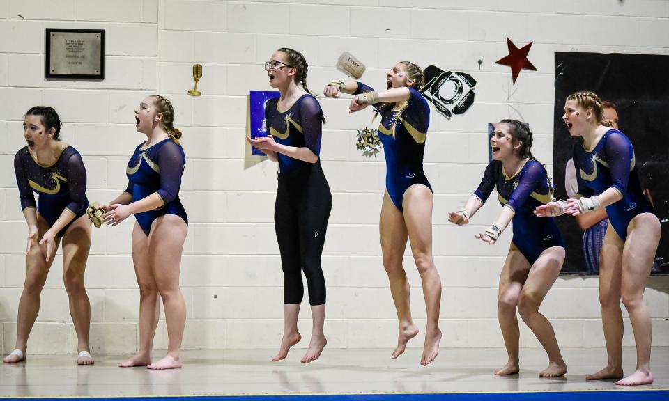 Essex High School team members cheer on a teammate at the Vermont gymnastics state championship at St. Johnsbury Academy on Saturday, Feb. 17, 2024.