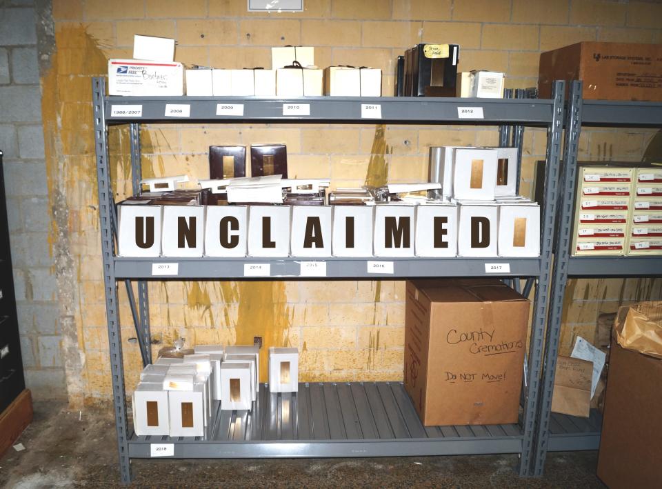 The cremated remains of more than 100 people sit on a shelf in a storage room in the Montgomery County Coroner's Office in 2019.