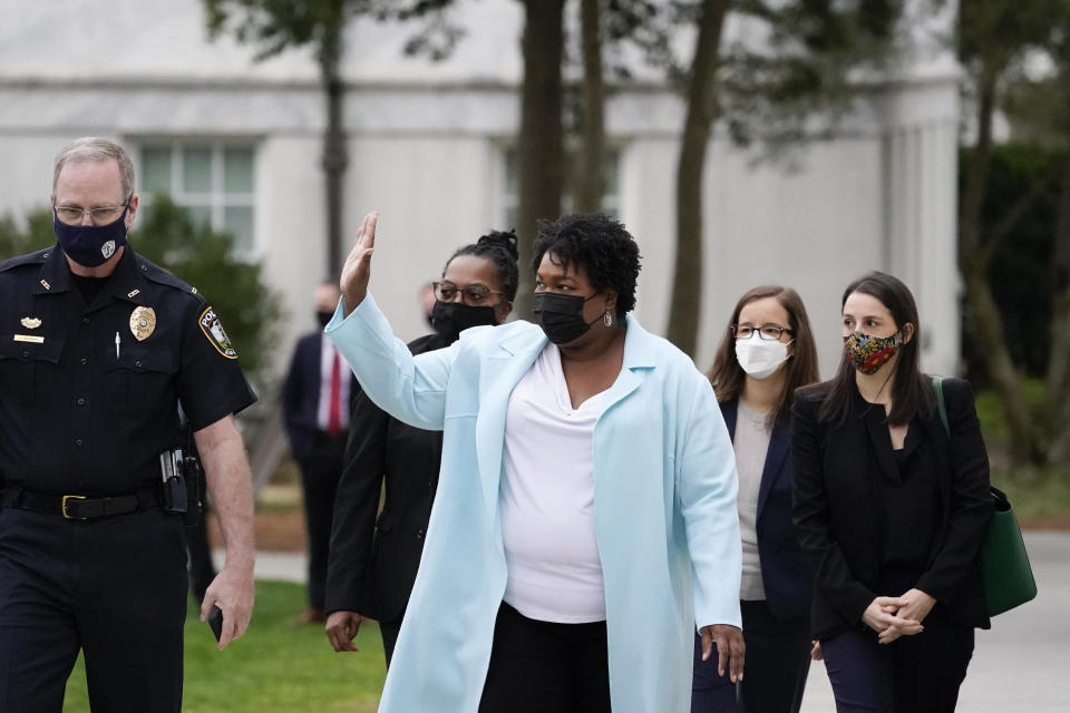 FILE - In this March 19, 2021, file photo Stacey Abrams waves during an event at Emory University in Atlanta. Abrams, Georgia's well-known voting rights advocate, is taking a carefully balanced approach in response to new laws many people have said are an attempt to suppress votes of people of color. When asked about the law changes, she is critical but measured. (AP Photo/Alex Brandon, File)