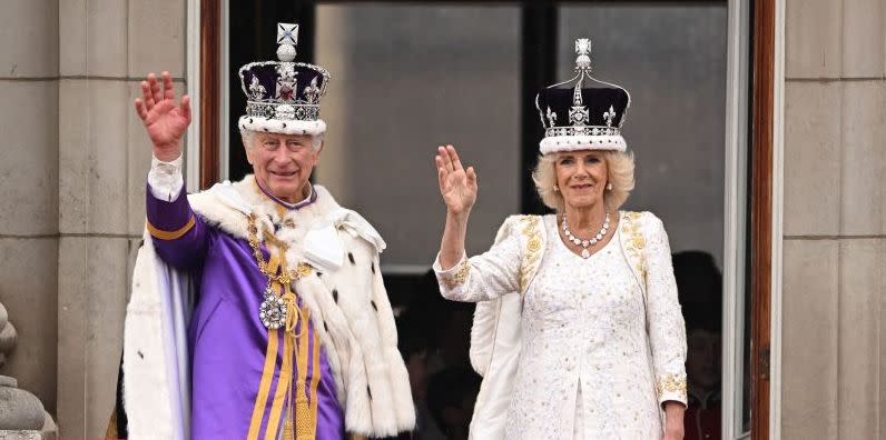topshot britains king charles iii wearing the imperial state crown, and britains queen camilla wearing a modified version of queen marys crown wave from the buckingham palace balcony after viewing the royal air force fly past in central london on may 6, 2023, after their coronations the set piece coronation is the first in britain in 70 years, and only the second in history to be televised charles will be the 40th reigning monarch to be crowned at the central london church since king william i in 1066 photo by oli scarff afp photo by oli scarffafp via getty images