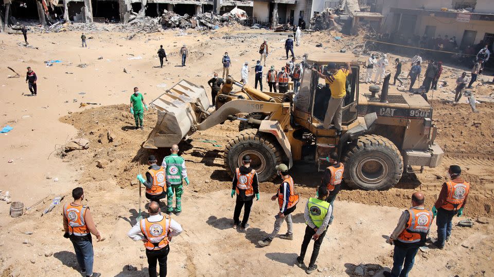 Palestinian forensic and civil defense workers recover bodies at the grounds of Al-Shifa, Gaza's largest hospital, which was reduced to rubble by a two-week Israeli raid, on April 8, 2024. - AFP/Getty Images