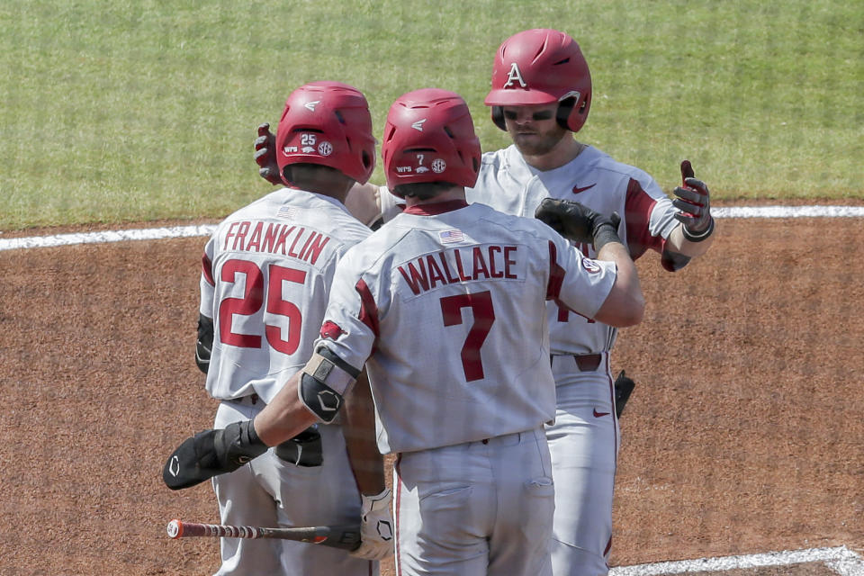 Arkansas' Cullen Smith (14) celebrates with teammates after hitting a two-run home run against Mississippi in the first inning of an NCAA college baseball game during the Southeastern Conference tournament Saturday, May 29, 2021, in Hoover, Ala. (AP Photo/Butch Dill)