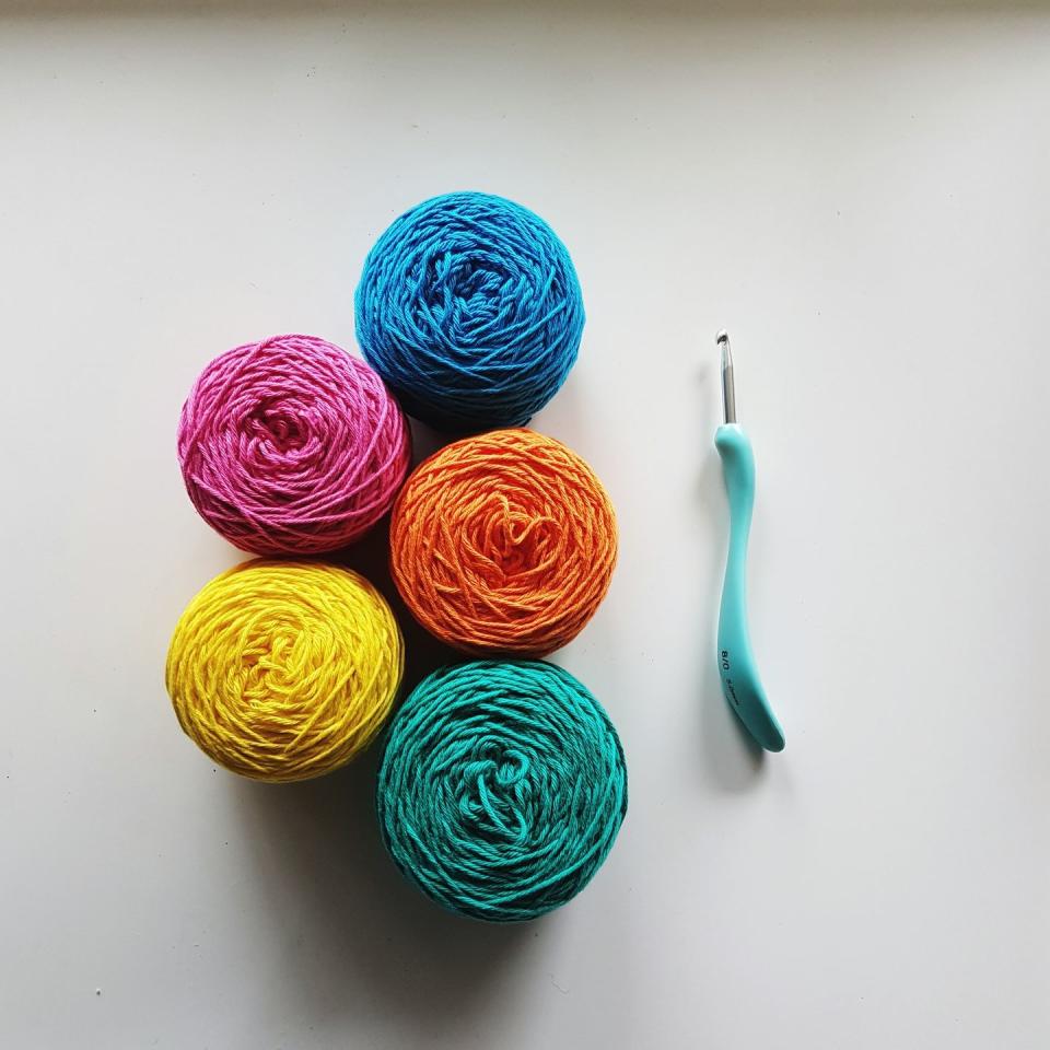 High Angle View Of Colorful Wools And Knitting Needle On Table