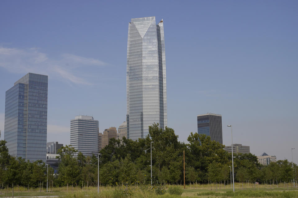 The Devon Energy Tower dwarfs other downtown buildings Monday, Sept. 27, 2021, in Oklahoma City. Oklahoma City-based Devon Energy Corporation has agreed to a $6.15 million settlement agreement with the federal government over allegations it underpaid royalties on federal leases, the U.S. Department of Justice announced Monday. (AP Photo/Sue Ogrocki)