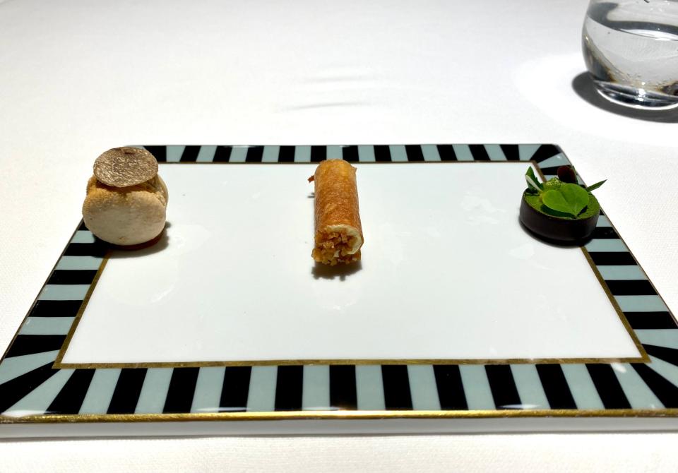 three small desserts on a tray at  Osteria Francescana