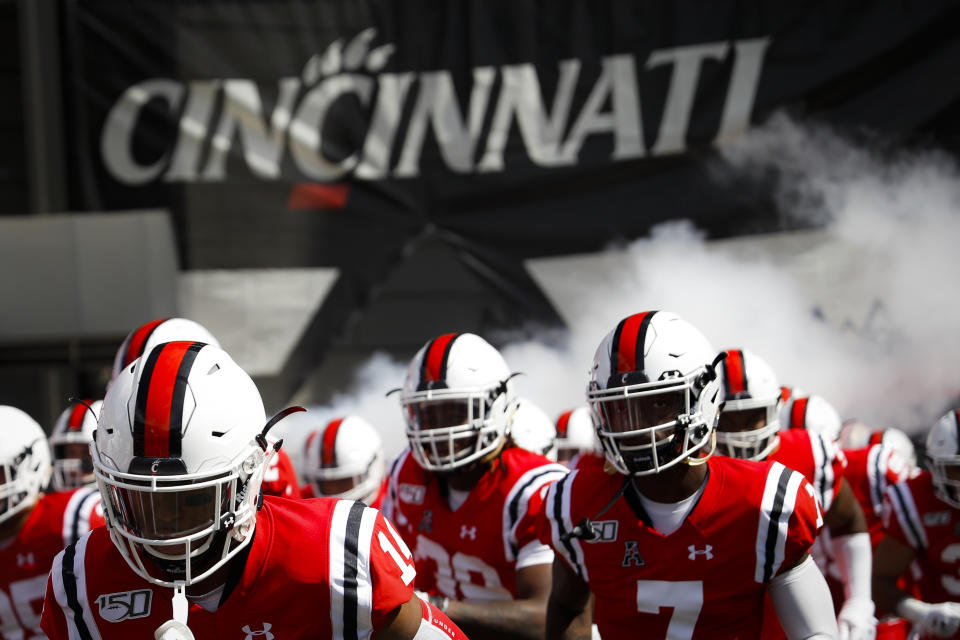 The Cincinnati Bearcats take the field before an NCAA college football game against Miami of Ohio, Saturday, Sept. 14, 2019, in Cincinnati. No. 8 Cincinnati’s game at Tulsa on Saturday has been postponed because of positive COVID-19 tests among Bearcats players. The American Athletic Conference announced Thursday, Oct. 15, 2020, the game is being rescheduled for Dec. 5.(AP Photo/John Minchillo)