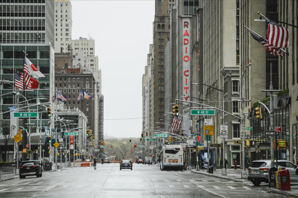 Pedestrians walk a mostly empty Sixth Avenue during the coronavirus outbreak, Friday, April 3, 2020, in New York. The new coronavirus causes mild or moderate symptoms for most people, but for some, especially older adults and people with existing health problems, it can cause more severe illness or death. (AP Photo/Frank Franklin II)