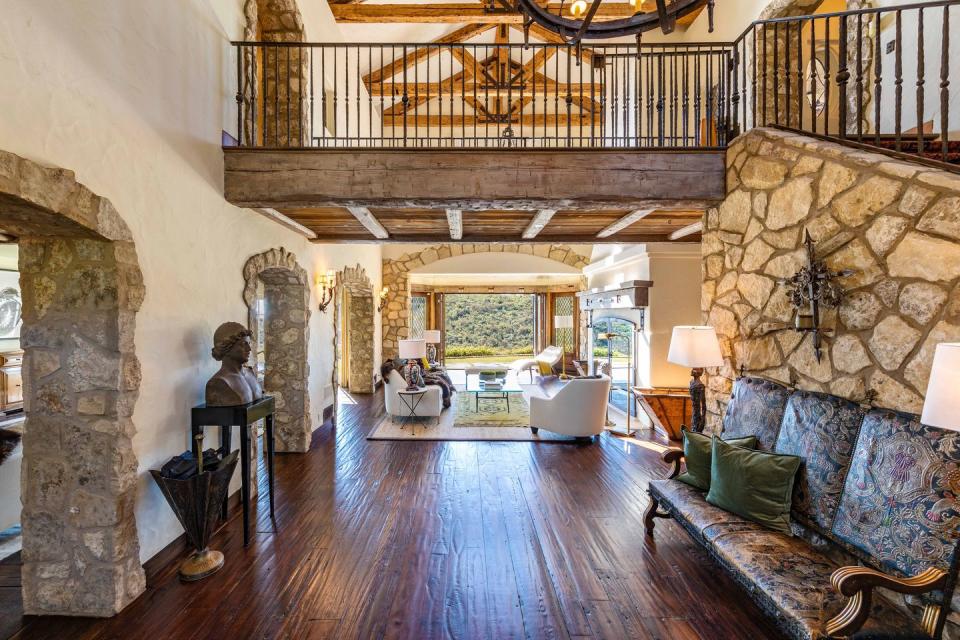 2) Exposed wood beams and stone-topped archways add character to the estate.