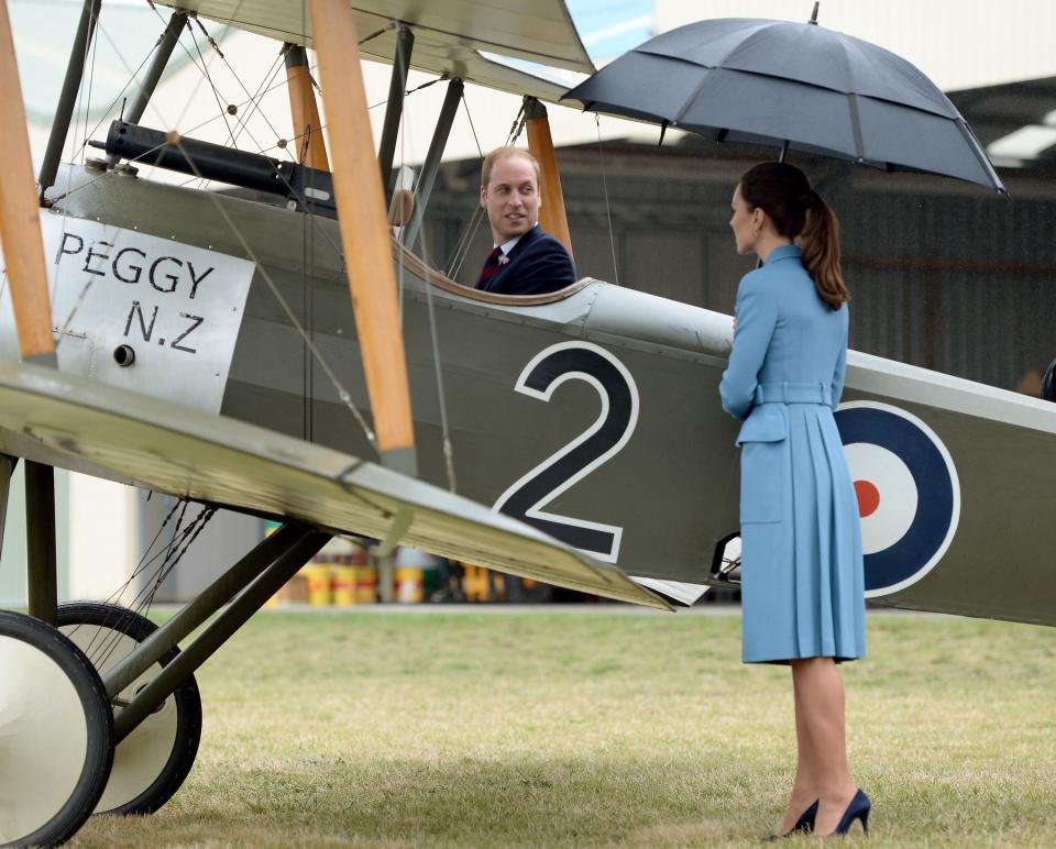 Britain's Catherine, Duchess of Cambridge watches her husband Prince William sit in the cockpit of a Sopwith Pup at the Omaka Aviation Heritage Centre near Blenheim