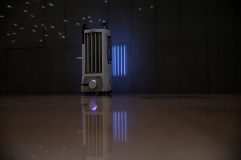 A self-driving robot sanitizes a wall with UV light during its demonstration at the headquarters of SK Telecom in Seoul