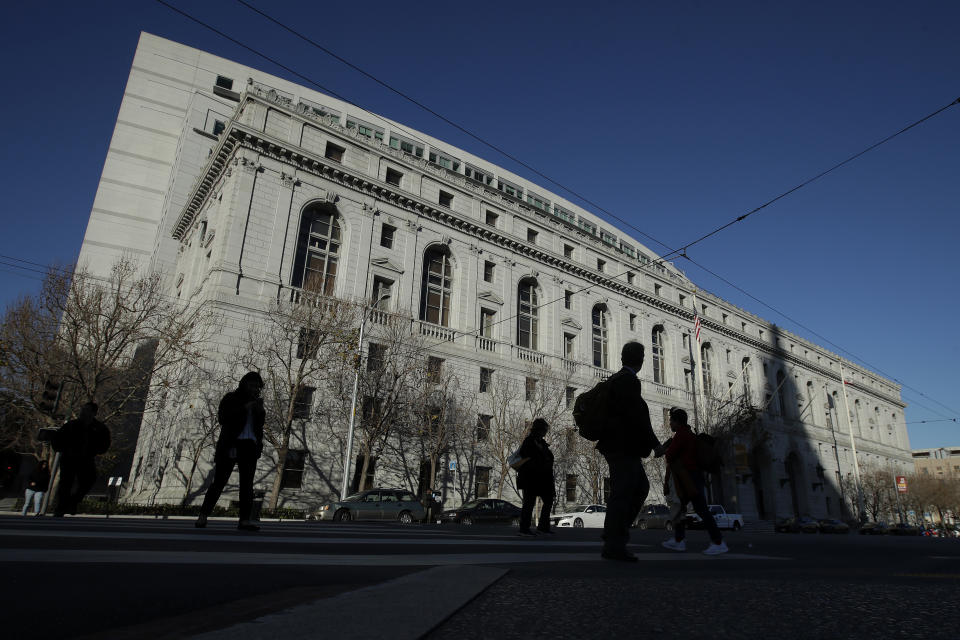 FILE - People walk past The Earl Warren Building, headquarters of the Supreme Court of California, on Jan. 7, 2020 in San Francisco. On Thursday, June 22, 2023, the Supreme Court of California ruled that police are not immune from civil lawsuits for misconduct that happens during investigations. (AP Photo/Jeff Chiu, File)