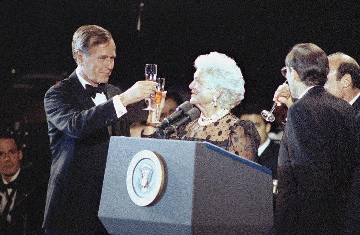 FILE - In this June 23, 1989, file photo, President George H.W. Bush and first lady Barbara Bush share a toast with Warren H. Phillips, chairman of Dow Jones and Co., right, at a gala in New York celebrating the Wall Street Journal's 100th birthday. The Bushes were married Jan. 6, 1945, and have had the longest marriage of any presidential couple in American history. (AP Photo/Ron Frehm, File)