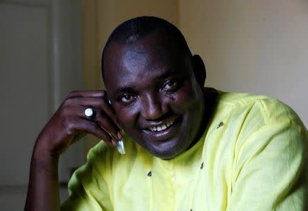 The new president of Gambia, Adama Barrow smiles as he makes a call at his home in Yarambamba, West Coast Region, Gambia December 3, 2016. REUTERS/ Thierry Gouegnon