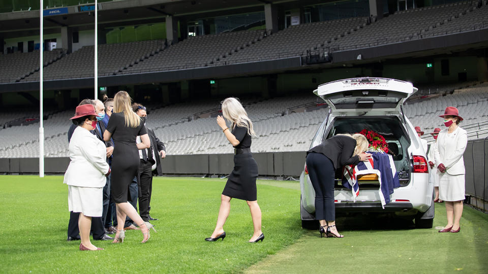 Family and friends are pictured at a service for Dean Jones at the MCG.