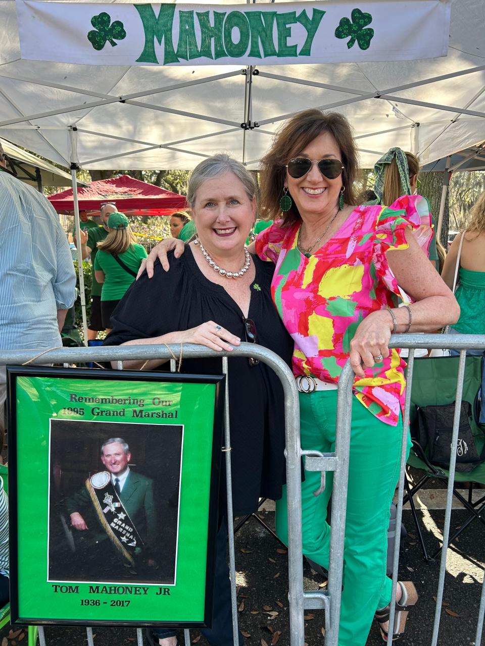 Kathleen Taylor (nee Mahoney) poses with a photo of her father and former St Pats parade grand marshal Tom Mahoney. Family member Molly Mahoney (right) said the family has been coming to the parade and securing their spot in front of the median on Oglethorpe Ave for the last 35 years.