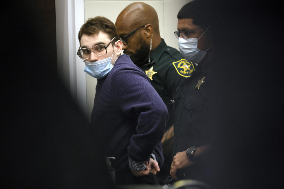 FILE - Marjory Stoneman Douglas High School shooter Nikolas Cruz is led from the courtroom after he was sworn in and waved his right to be present at the school while the jury walks through the crime scene, Thursday, Aug. 4, 2022, during the penalty phase of his trial at the Broward County Courthouse in Fort Lauderdale, Fla. Cruz previously plead guilty to all 17 counts of premeditated murder and 17 counts of attempted murder in the 2018 shootings. (Mike Stocker/South Florida Sun Sentinel via AP, Pool, File)