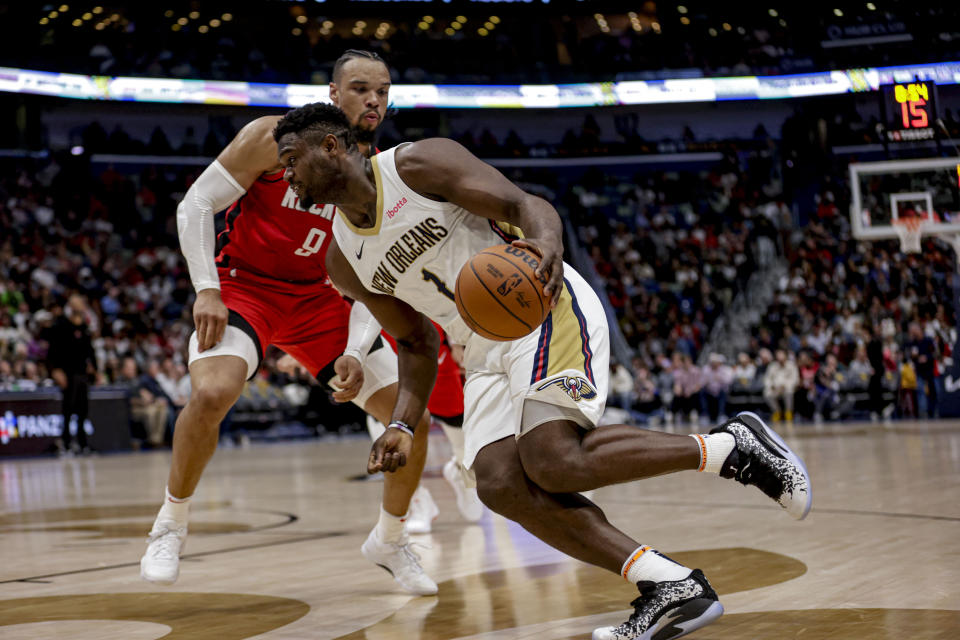 New Orleans Pelicans forward Zion Williamson (1) drives past Houston Rockets forward Dillon Brooks (9) during the second half of an NBA basketball game in New Orleans, Thursday, Feb. 22, 2024. (AP Photo/Derick Hingle)