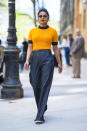 <p>Actress Priyanka looked too cool for school while dashing from meetings in New York wearing a tangerine-coloured, cropped fluffy jumper by Ganni with high-waisted, wide-legged trousers and some slim sunnies.<br><em>[Photo: Getty]</em> </p>