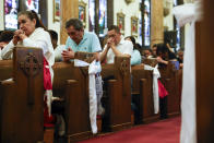 Parishioners pray during Easter Mass at Sacred Heart of Jesus and Saint Patrick, Sunday, March 31, 2024, in Baltimore, Md. (AP Photo/Julia Nikhinson)