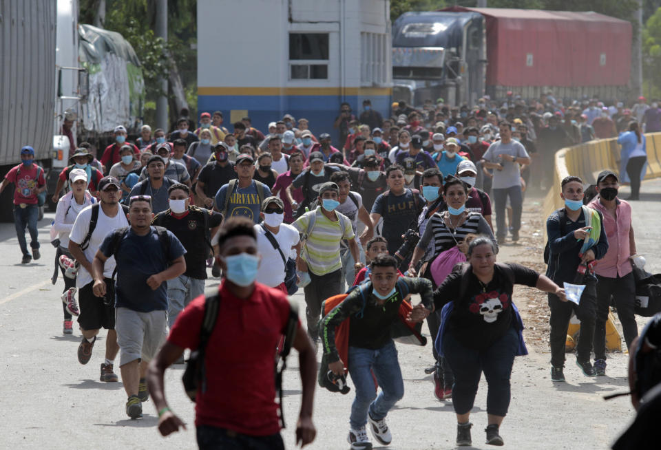 Migrants attempt to cross the border from Corinto, Honduras, into Corinto, Guatemala, Thursday, Oct. 1, 2020. Hundreds of migrants walked from San Pedro Sula, Honduras to the Guatemala border, testing a well-trod migration route now in times of the new coronavirus. (AP Photo)