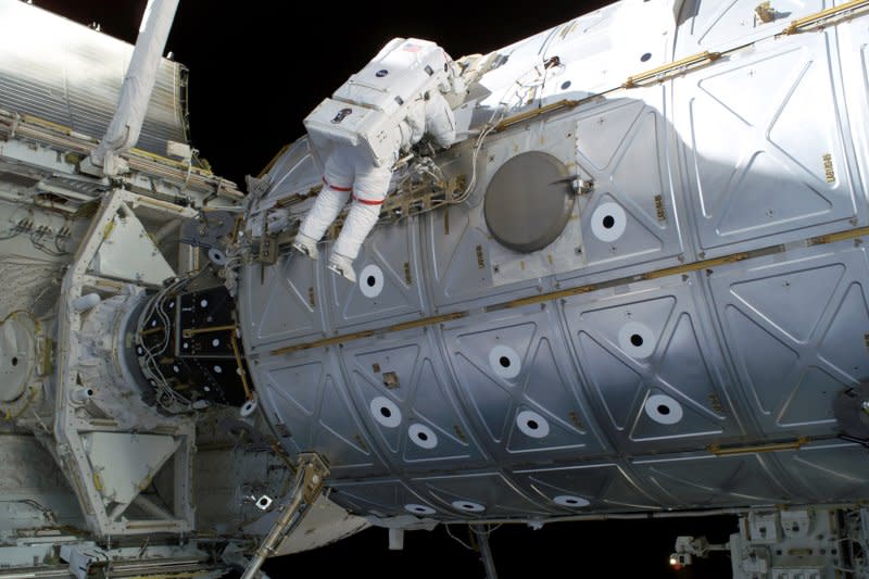 Mission Specialist Soichi Noguchi traverses along the Destiny laboratory of the International Space Station between tasks of the mission's third spacewalk on August 5, 2005. Two days earlier, in the first emergency repair conducted in space, astronauts fixed a potentially dangerous problem by removing two strips of protruding cloth from the underside of the space shuttle Discovery. File Photo courtesy NASA