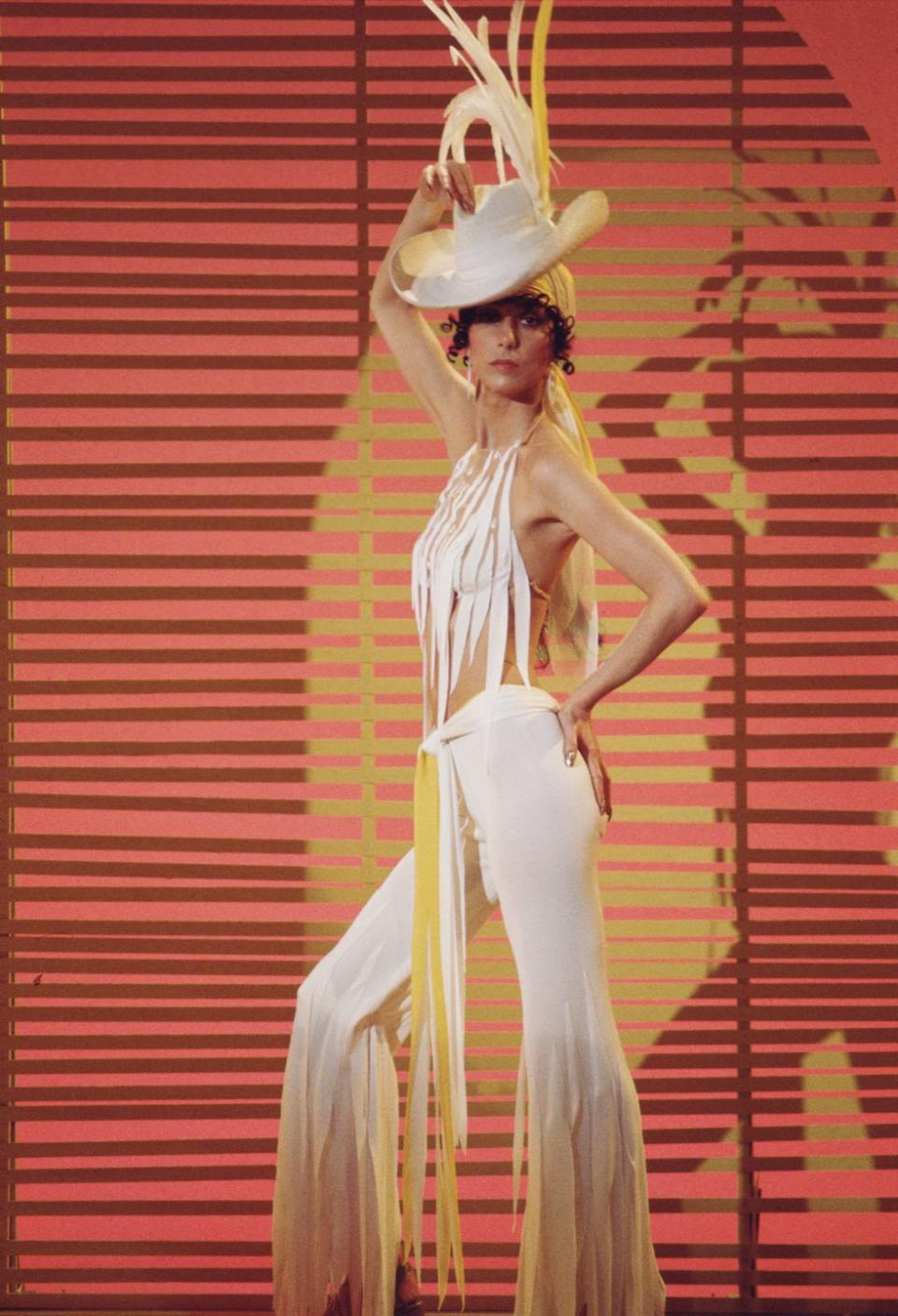 <p>On <em>The Sonny and Cher Show</em> in a white hat, cutout halter top, and tiered pants. </p>