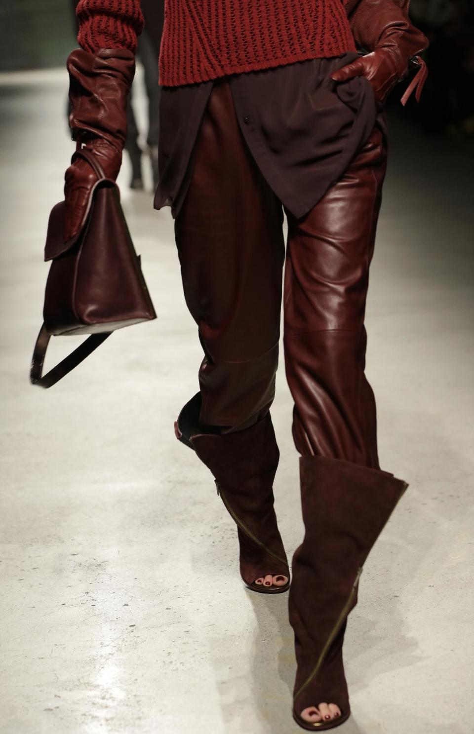 A model walks the runway during the presentation of the Kenneth Cole Fall 2013 fashion collection during Fashion Week in New York, Thursday, Feb. 7, 2013. (AP Photo/Kathy Willens)