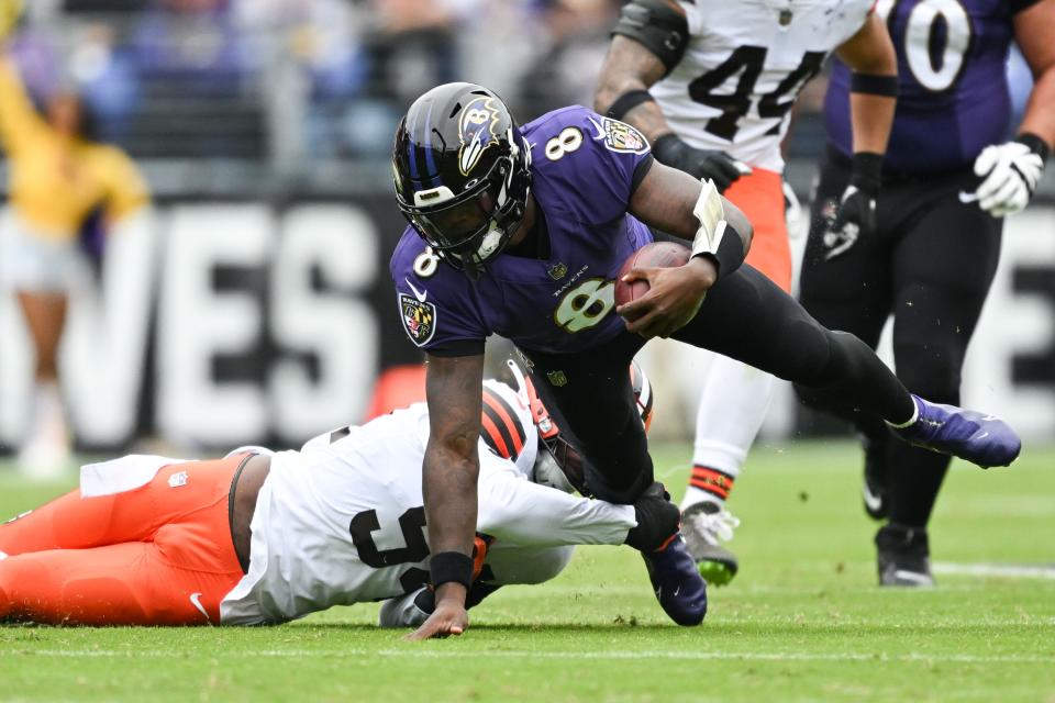 Oct 23, 2022; Baltimore, Maryland, USA;  Baltimore Ravens quarterback Lamar Jackson (8) scrambles away from Cleveland Browns defensive end Myles Garrett (95) during the first half at M&T Bank Stadium. Mandatory Credit: Tommy Gilligan-USA TODAY Sports