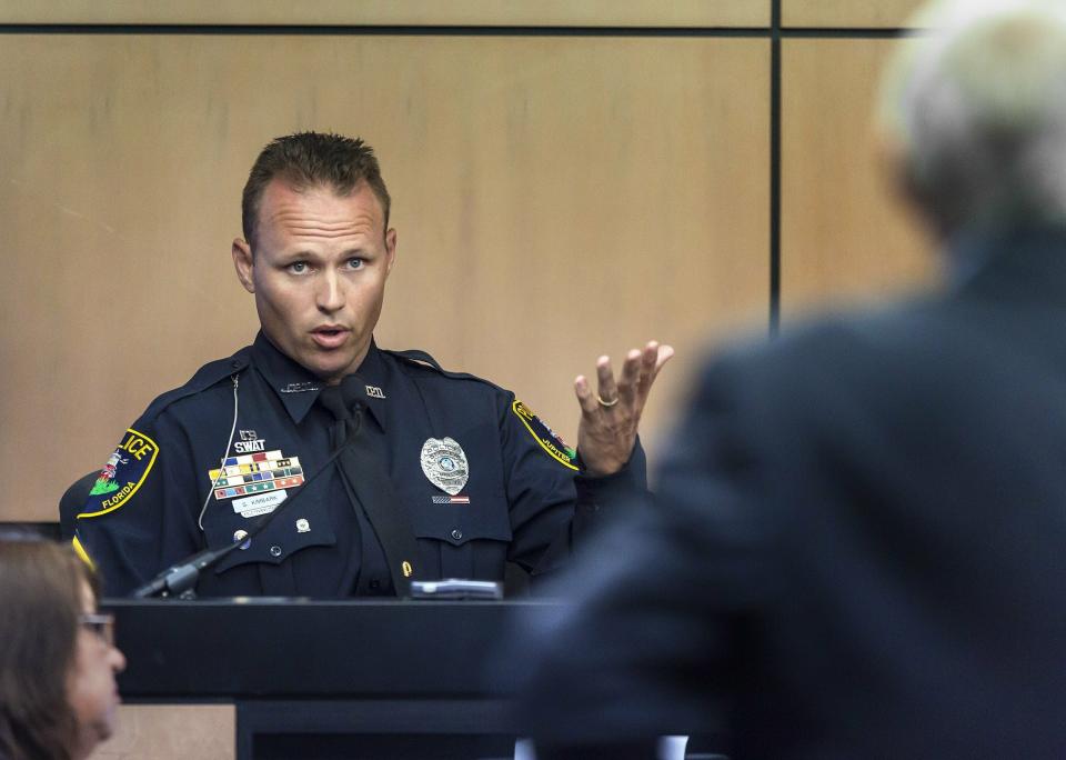 Jupiter police officer Scott Kimbark is questioned as he testifies during a motion hearing in New England Patriots owner Robert Kraft prostitution solicitation case, Wednesday, May 1, 2019, in West Palm Beach, Fla. Kimbark stopped the car containing Kraft. Kraft's attorneys argue that undercover surveillance videos allegedly showing their client paying for sex at a Jupiter day spa should be ruled inadmissible and the evidence thrown out. (Lannis Waters/Palm Beach Post via AP, Pool)