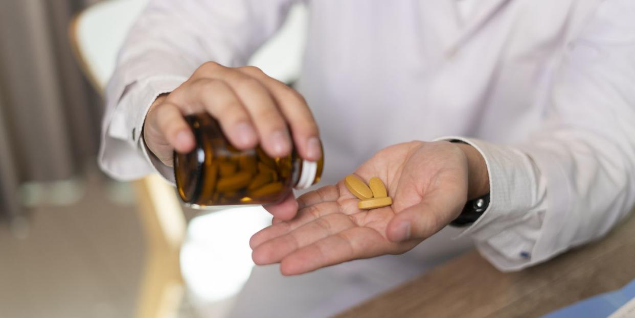 man hand taking medicine