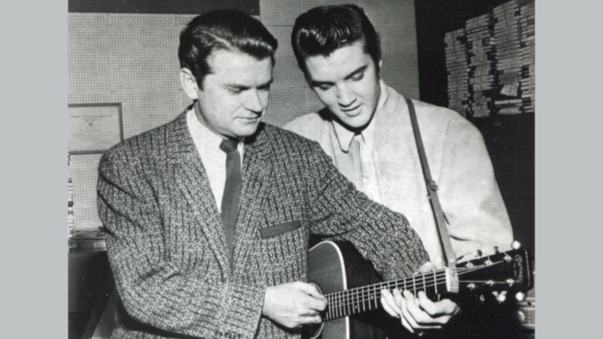  Sun Records owner Sam Phillips and Elvis Presley both fingering a chord on the same guitar, United States, 1956.  