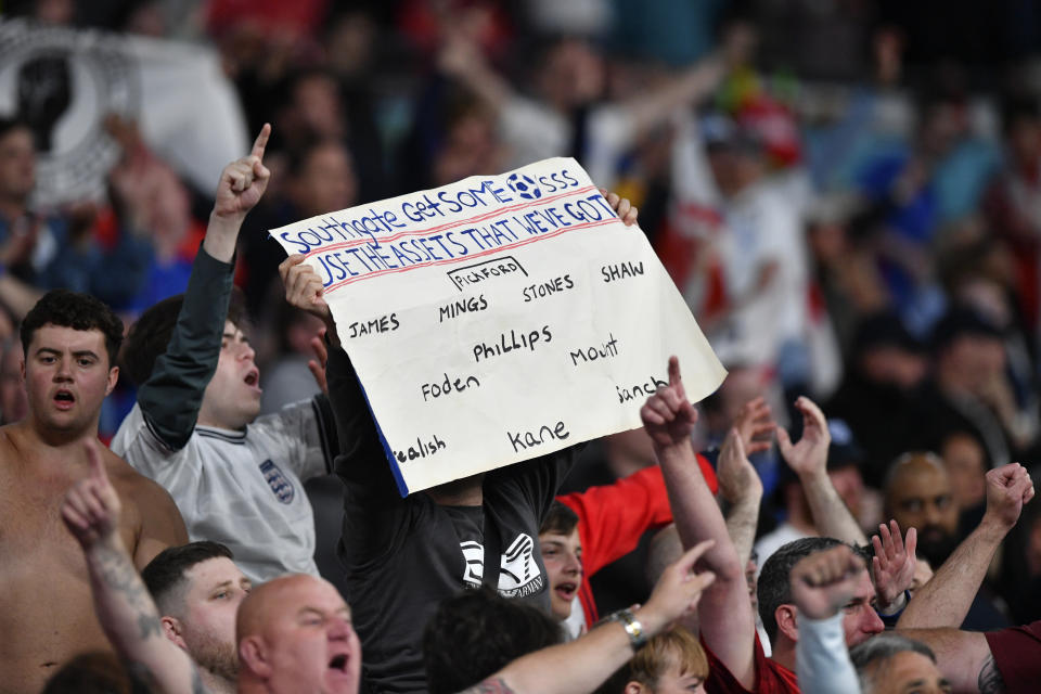 An England supporter holds up a poster suggesting his team lineup to England's manager Gareth Southgate during the Euro 2020 soccer championship group D match between the Czech Republic and England at Wembley stadium in London, Tuesday, June 22, 2021. (Justin Tallis, Pool photo via AP)