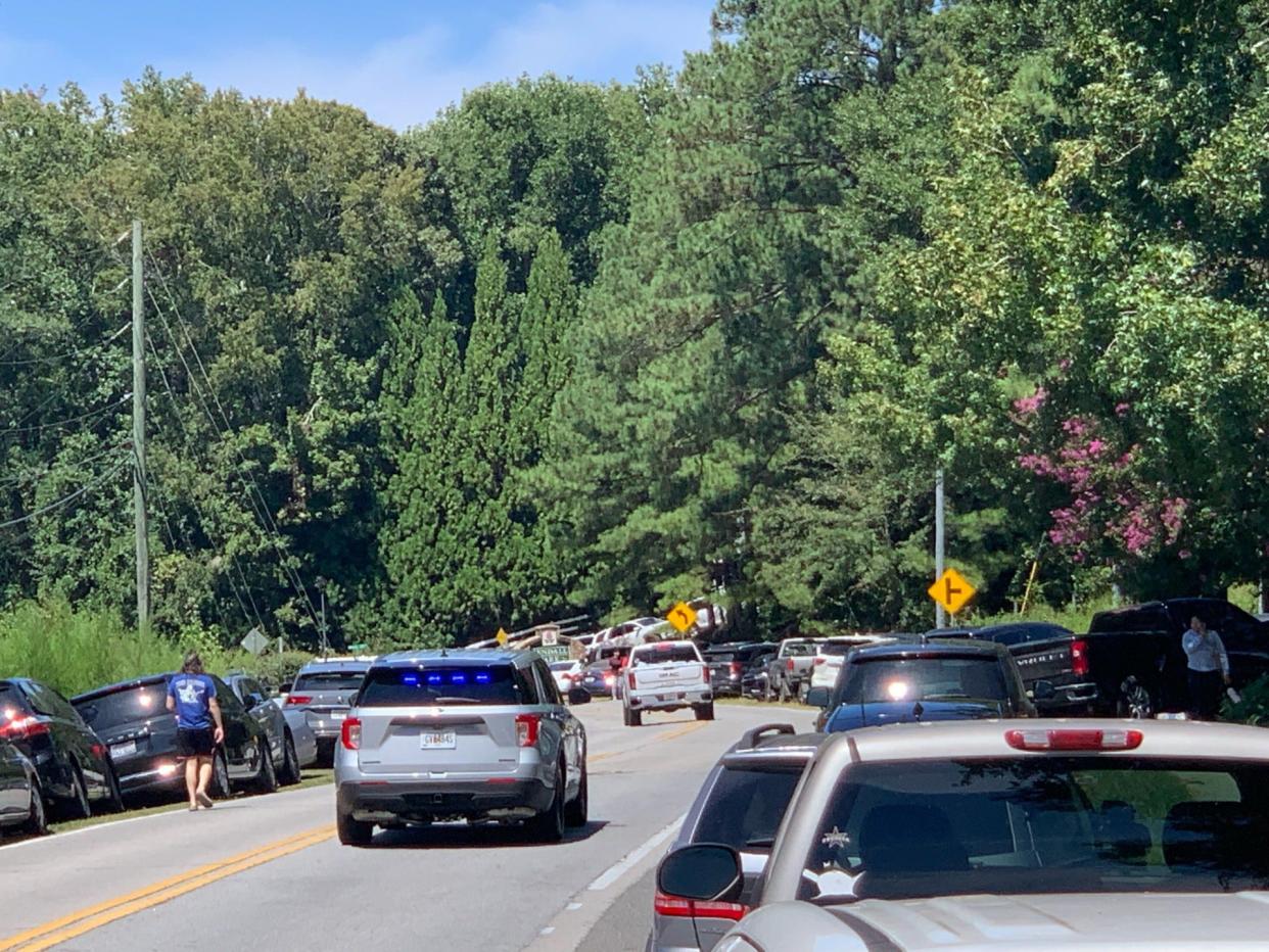 Parents cars line the sides of the road near Apalachee High School in Winder, Georgia after a shooting occurred at the school on Wednesday, Sept. 4, 2024.