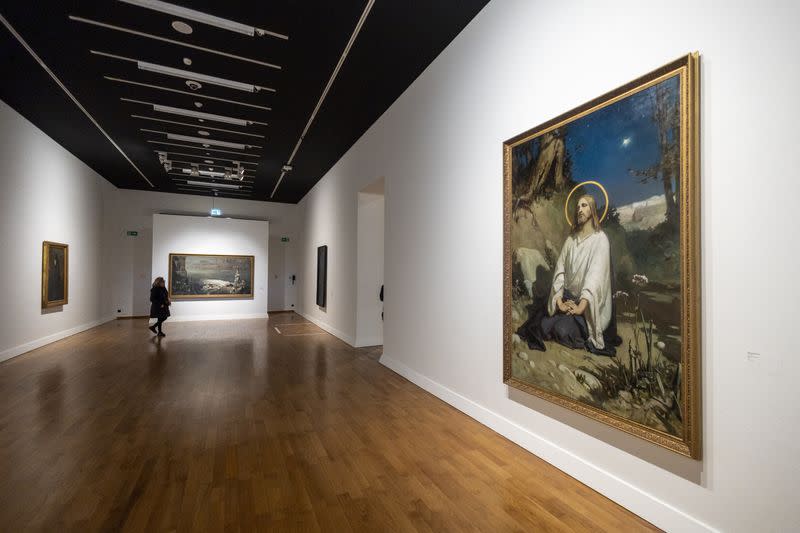 Visitors look at paintings from the collection of the National Art Gallery of Kyiv during the "From Dusk To Dawn" exhibition at the Rath Museum in Geneva