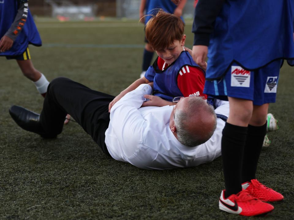 Prime Minister Scott Morrison accidentally knocks over a child during a visit to the Devonport Strikers Soccer Club, which is in the electorate of Braddon, on May 18, 2022 in Devonport, Australia.