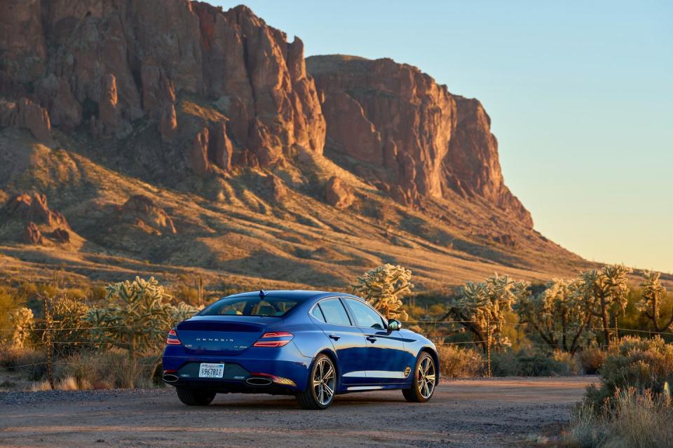 a car parked on a road with a mountain in the background