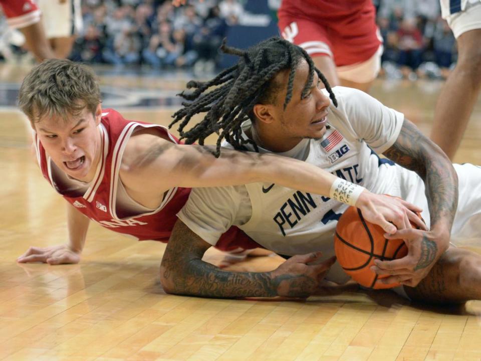 Indiana’s Gabe Cupps, left, and Penn State’s Ace Baldwin Jr., right, scramble for a loose ball during the second half of an NCAA college basketball game Saturday Feb. 24, 2024, in State College, Pa. (AP Photo/Gary M. Baranec)